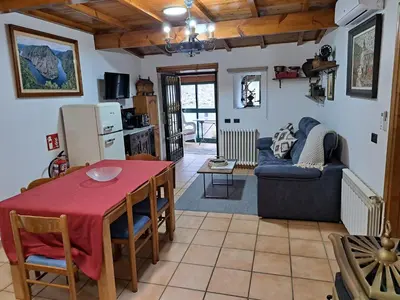 a kitchen and living room with a table and a couch at Casa do sequeiro in Parada del Sil