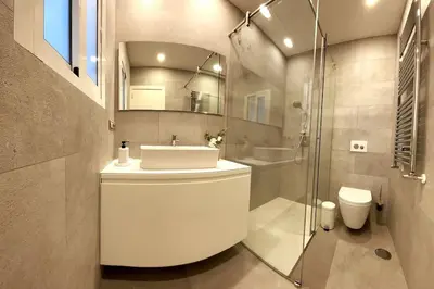 a bathroom with a sink and a shower and a toilet at H7072 Luxury apartments in Santiago de Compostela