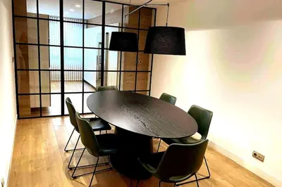 a dining room with a black table and chairs at H7072 Luxury apartments in Santiago de Compostela