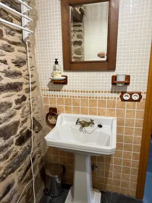 a bathroom with a sink and a mirror at Casa Rural Los Cabritos de Tomás in Puebla de Sanabria