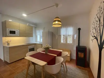 a kitchen with a table and a dining room at Neverending Nature León in Tremor de Arriba