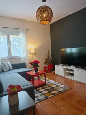 a living room with a couch and a flat screen tv at Neverending Nature León in Tremor de Arriba