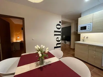 a kitchen with a table with a vase of flowers on it at Neverending Nature León in Tremor de Arriba