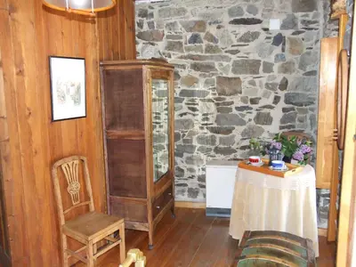 a room with a table and a stone wall at Casa Trallera in Colinas del Campo de Martín Moro