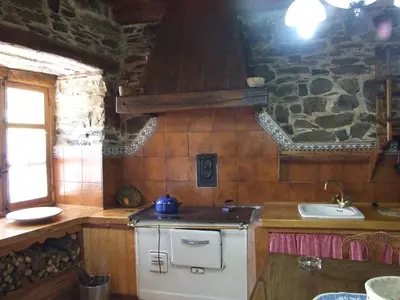 a kitchen with a stove and a sink at Casa Trallera in Colinas del Campo de Martín Moro