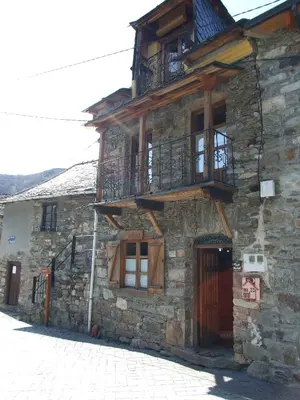 an old stone building with a balcony on it at Casa Trallera in Colinas del Campo de Martín Moro