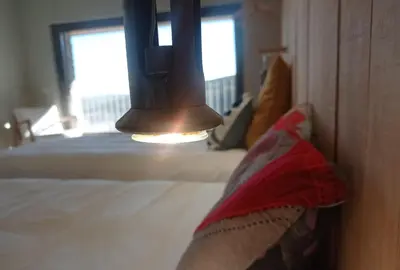 a room with a bed with a bell on the wall at Balneario de Calabor in Calabor