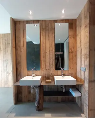 a bathroom with two sinks and two mirrors at Balneario de Calabor in Calabor