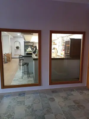 two mirrors in a room with a kitchen at O novo alto do couso in Ourense