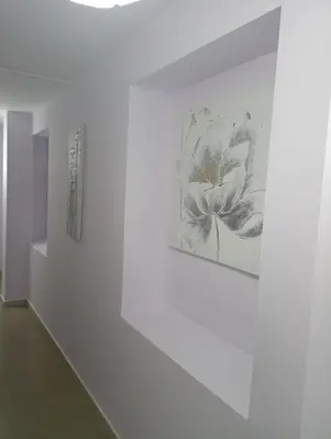 two paintings of a flower on a white wall at O novo alto do couso in Ourense