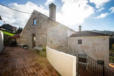 an old stone building with a brick walkway next to it at Villa Vaquiña in Airoa