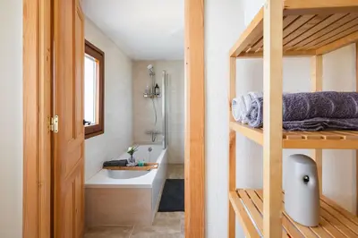 a bathroom with a tub and a toilet and a sink at Villa Vaquiña in Airoa