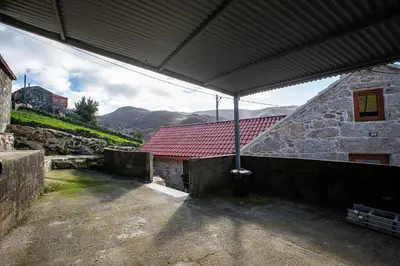 an outside view of a building with a red roof at Villa Vaquiña in Airoa