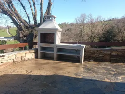 a bedroom with a bed and a stone wall at Casa Arza in Tríacastela