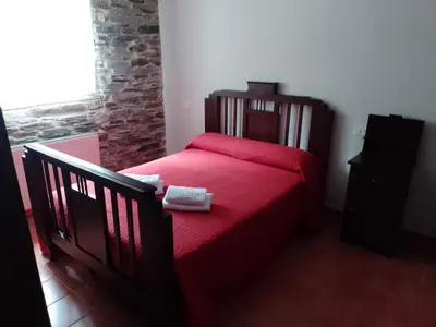 an empty room with a brick wall and a window at Casa Arza in Tríacastela