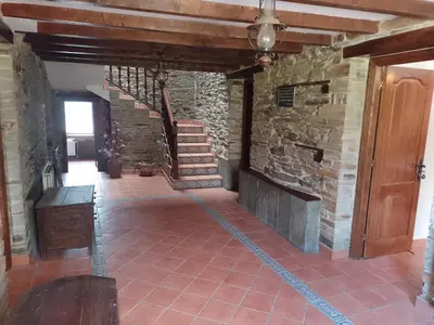 a staircase in a house with a stone wall at Casa Arza in Tríacastela
