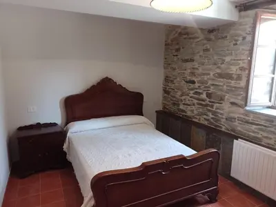 a bedroom with a mirror and a bed in a room at Casa Arza in Tríacastela