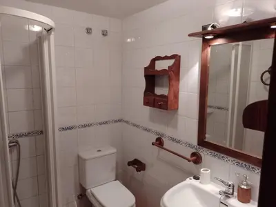 a hallway in a house with a stone wall at Casa Arza in Tríacastela