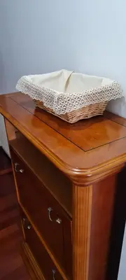 a basket sitting on top of a wooden table at Apartamentos Tesón Ribadeo in Ribadeo