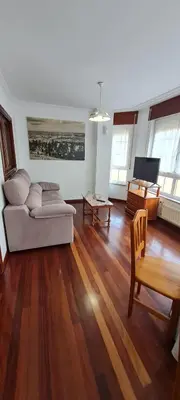 a living room with a couch and a table at Apartamentos Tesón Ribadeo in Ribadeo