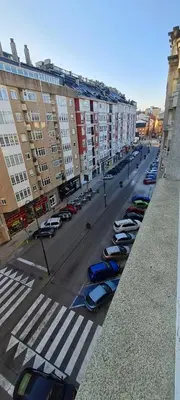 a group of cars parked in a parking lot at Apartamentos Tesón Ribadeo in Ribadeo