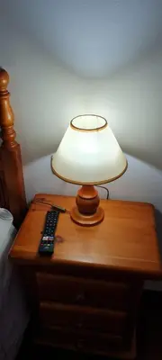 a lamp on top of a table with a remote control at Apartamentos Tesón Ribadeo in Ribadeo