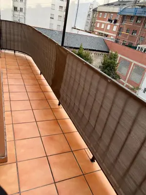 a balcony with a tile floor and a fence at Alojamiento estilo Boho con mucho encanto in Ponferrada