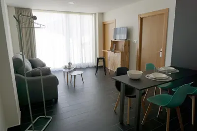 a living room with a couch and a table and chairs at Lumen Place APARTAMENTOS in Mondoñedo