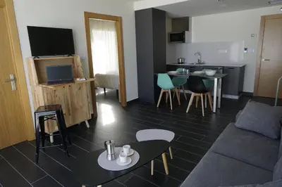 a living room with a couch and a table at Lumen Place APARTAMENTOS in Mondoñedo