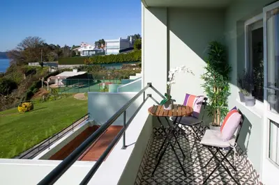 a balcony with two chairs and a table with a view at Apartamento Playa Lago in A Coruña