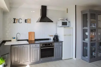 a kitchen with a white refrigerator and a sink at Apartamento Playa Lago in A Coruña