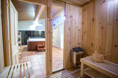 a wooden room with a bench and a bathroom at Casa Peña Dura in Lalín