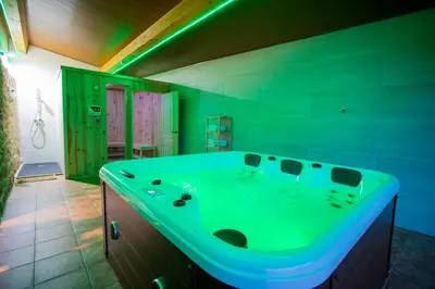 a bathroom with a green tub in a room at Casa Peña Dura in Lalín