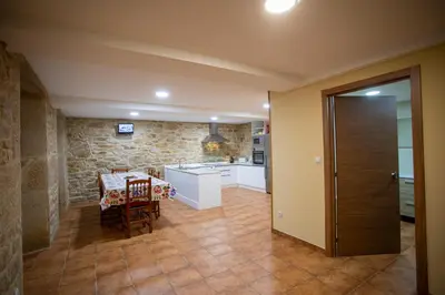 a kitchen with a table and a dining room at Casa Peña Dura in Lalín