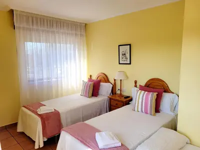 a hotel room with two beds and a window at Vilariño Moscoso in Arzúa
