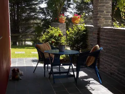 a table and two chairs on a patio at Apartamentos Guidan in Ribadeo