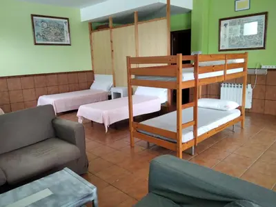 a living room with two bunk beds and a couch at A CONDA-habitación privada in Arzúa