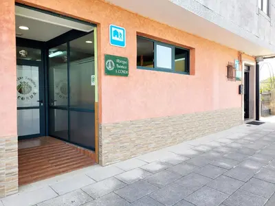 an entrance to a building with a glass door at A CONDA-habitación privada in Arzúa