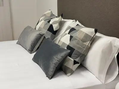 a white bed with four pillows on it at Oktheway Pedro Saco Street 2 in Sarria