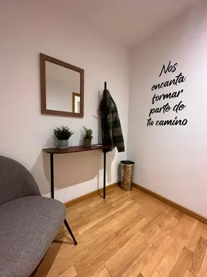a living room with a couch and a mirror on the wall at Oktheway Pedro Saco Street 2 in Sarria