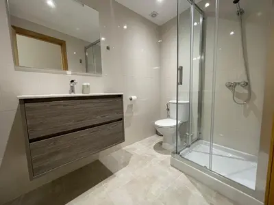 a bathroom with a toilet and a glass shower at Oktheway Pedro Saco Street 2 in Sarria
