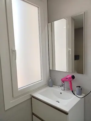 a bathroom sink with a pink faucet and a mirror at O Abeiro do Eume in Puentedeume
