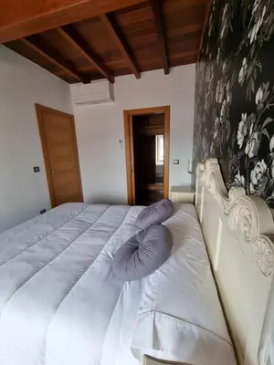 a bed with a pillow on the side of it at Apartamentos Turísticos Betanzos in Betanzos