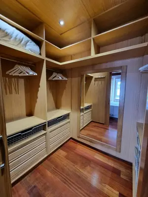 a walk in closet with wooden walls and wooden floors at Apartamentos Turísticos Betanzos in Betanzos