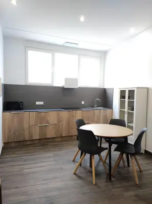 a kitchen with a table and chairs in a room at Apartamentos Turísticos Betanzos in Betanzos