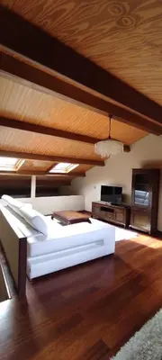 a bedroom with a large bed and a wooden ceiling at Apartamentos Turísticos Betanzos in Betanzos