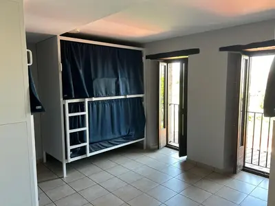 a room with a closet with a blue curtain at Albergue San Anton in Melide
