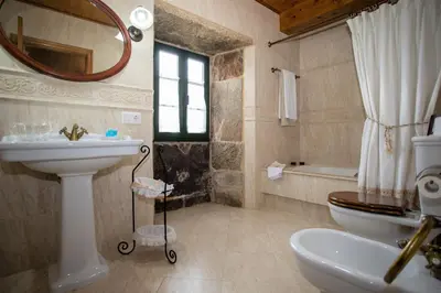 a bathroom with a sink and a toilet and a mirror at Casa de Barreiro in Teijeiro