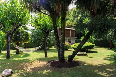 an old stone house with a staircase in the yard at Casa de Barreiro in Teijeiro