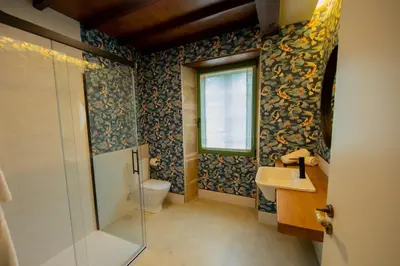 a bathroom with a toilet and a sink and a window at CASA CON ENCANTO (o Refuxio) in Merza